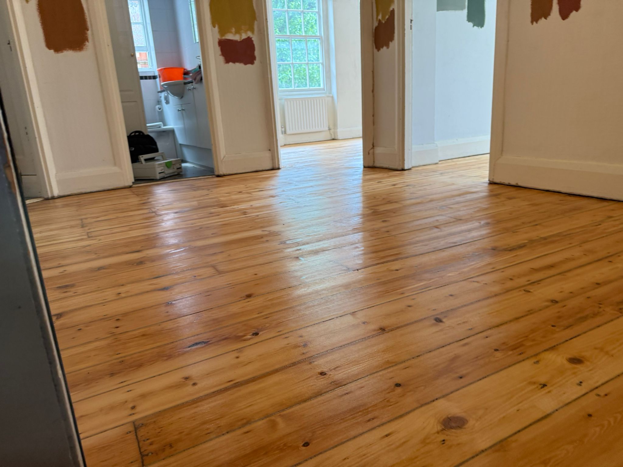 Freshly restored pine floorboards gleaming after Wood Floor Sanding in a Stamford Hill home.