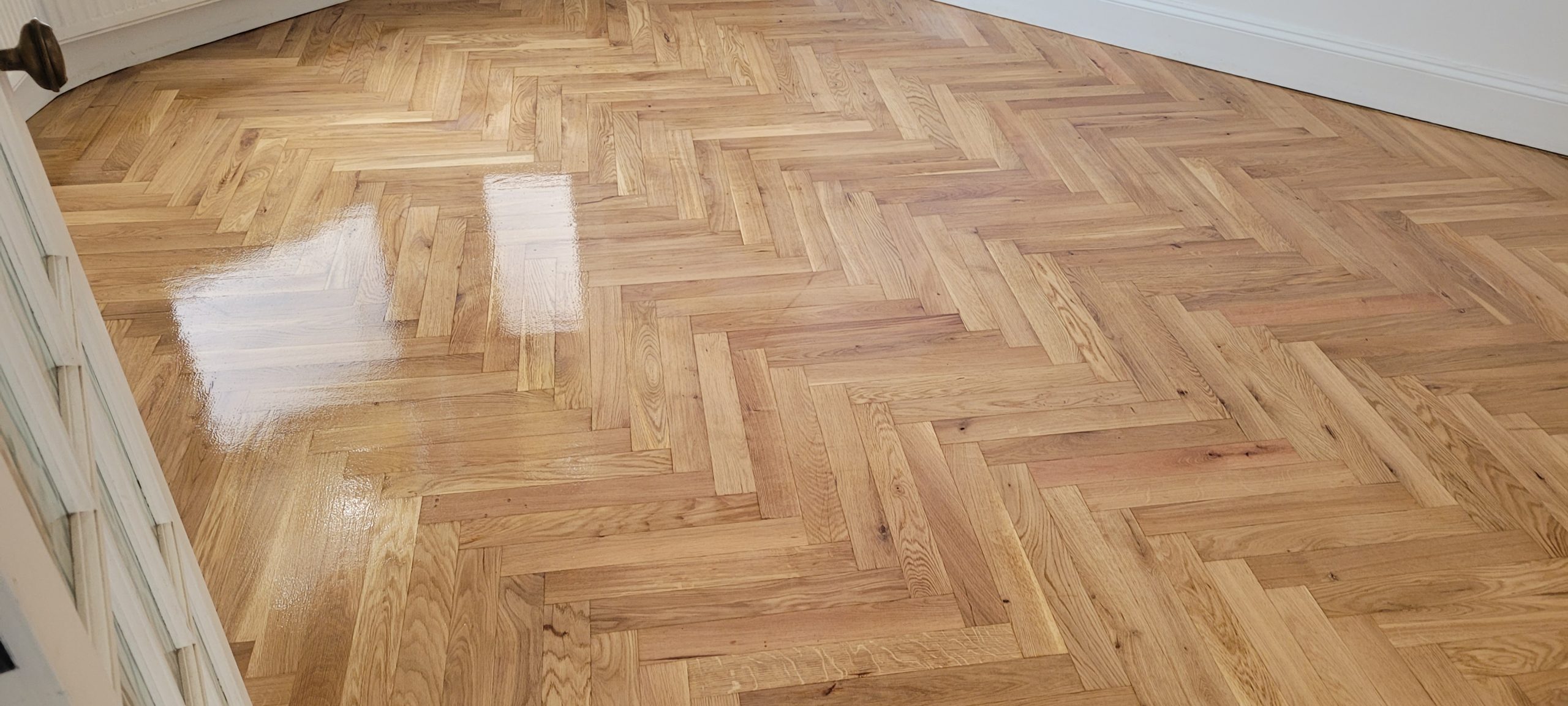 Parquet Floor Sanding in Stamford Hill on an engineered oak herringbone parquet floor, finished with a smooth satin seal for a clean, reflective look.