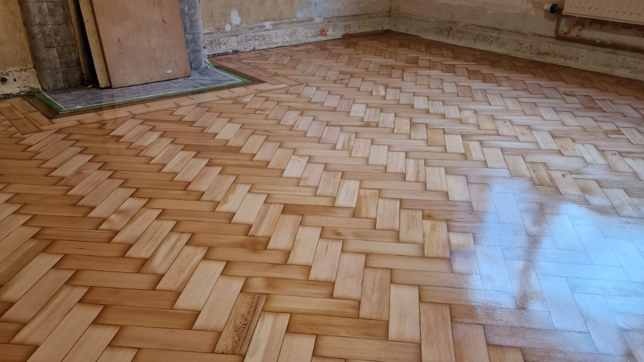 Parquet Floor Sanding in Stamford Hill on a herringbone oak parquet floor, showing freshly sanded timber ready for sealing and a smooth protective finish.